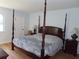 Serene primary bedroom with a four-poster bed, hardwood floors, and calming decor at 224 Cypress Ln # 224, Oldsmar, FL 34677