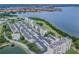 Aerial view of bayside condo community featuring landscaping, golf course, and pool at 2614 Cove Cay Dr # 207, Clearwater, FL 33760