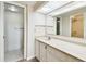 Bright bathroom with a marble countertop vanity and a spacious walk-in closet featuring tiled floor at 2614 Cove Cay Dr # 207, Clearwater, FL 33760