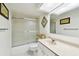 Standard bathroom featuring a shower/tub combo with sliding glass doors and a marble countertop vanity at 2614 Cove Cay Dr # 207, Clearwater, FL 33760