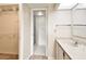 Bright bathroom featuring a marble countertop vanity, walk-in closet, and glass-door shower stall at 2614 Cove Cay Dr # 207, Clearwater, FL 33760