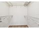 Walk-in closet with wire shelving on either side offering ample storage space at 2614 Cove Cay Dr # 207, Clearwater, FL 33760