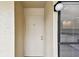 Unit 207 entrance door is a clean, white door with modern handle and door lock set at 2614 Cove Cay Dr # 207, Clearwater, FL 33760
