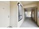 Well-lit hallway with unit entrance, showcasing accessible design and neutral tones at 2614 Cove Cay Dr # 207, Clearwater, FL 33760