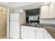 Kitchen area featuring modern cabinetry, granite countertops, and a pass-through to living area at 2614 Cove Cay Dr # 207, Clearwater, FL 33760