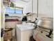 Laundry room with a washer and dryer, shelving, and a small window at 2614 Cove Cay Dr # 207, Clearwater, FL 33760