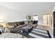 Comfortable living room featuring a sectional sofa, striped rug and an ottoman coffee table at 2614 Cove Cay Dr # 207, Clearwater, FL 33760