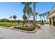 Beautiful outdoor patio space with lush landscaping, fountain and views of the golf course at 2614 Cove Cay Dr # 207, Clearwater, FL 33760