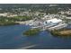 Aerial shot of a marina featuring numerous boats docked in the water, surrounded by lush greenery and buildings at 2869 Thistle N Ct, Palm Harbor, FL 34684