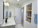 Bright bathroom with modern black framed mirror, open door, and built-in decorative shelf at 2869 Thistle N Ct, Palm Harbor, FL 34684