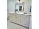 Modern bathroom vanity with quartz countertop, sleek mirror, and contemporary lighting creating a stylish space at 2869 Thistle N Ct, Palm Harbor, FL 34684