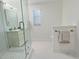 Bright bathroom features a glass-enclosed shower and a vanity with a modern mirror at 2869 Thistle N Ct, Palm Harbor, FL 34684