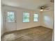 Bright bedroom with two windows and a door to the outside at 2869 Thistle N Ct, Palm Harbor, FL 34684