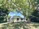 A charming single-story home featuring lush trees and a well-maintained lawn at 2869 Thistle N Ct, Palm Harbor, FL 34684