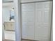Hallway featuring a bathroom with modern fixtures and white cabinets, providing both functionality and style at 2869 Thistle N Ct, Palm Harbor, FL 34684