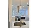 Bright kitchen featuring an island, stainless range hood, and white countertops at 2869 Thistle N Ct, Palm Harbor, FL 34684