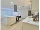 Well-lit kitchen featuring an island, stainless appliances, and white countertops at 2869 Thistle N Ct, Palm Harbor, FL 34684