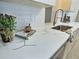 Modern white countertop with marble veining, stainless sink, and bronze faucet at 2869 Thistle N Ct, Palm Harbor, FL 34684