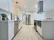 Modern eat-in kitchen with stainless steel appliances, sleek white cabinets, and hardwood flooring at 2869 Thistle N Ct, Palm Harbor, FL 34684