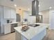 Modern eat-in kitchen with stainless steel appliances, sleek white cabinets, and a kitchen island at 2869 Thistle N Ct, Palm Harbor, FL 34684