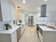 Bright kitchen boasts white cabinets, stainless steel appliances, and a spacious layout at 2869 Thistle N Ct, Palm Harbor, FL 34684