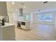 Open-concept kitchen featuring stainless steel appliances, island cooktop, and plenty of counter space at 2869 Thistle N Ct, Palm Harbor, FL 34684