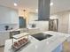 Open kitchen showcases an island cooktop with white countertops and a modern range hood at 2869 Thistle N Ct, Palm Harbor, FL 34684