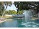 Beautiful Highland Lakes pond featuring a majestic water fountain and pristine landscaping at 2869 Thistle N Ct, Palm Harbor, FL 34684