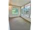 Enclosed sunroom offers a relaxing space with multiple windows for enjoying the outdoors at 2869 Thistle N Ct, Palm Harbor, FL 34684
