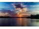 A beautiful sunset over the water, casting vibrant colors across the sky and reflecting on the calm surface at 2869 Thistle N Ct, Palm Harbor, FL 34684