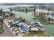 Aerial view of waterfront homes each with private docks and boats, nestled in a tranquil canal community at 301 Boca Ciega Dr, Madeira Beach, FL 33708