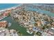 Expansive aerial view of a coastal neighborhood featuring waterways, homes and views of the beach and ocean at 301 Boca Ciega Dr, Madeira Beach, FL 33708