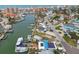 An aerial shot shows a waterfront property with docks, boats, and a neighborhood near a canal at 301 Boca Ciega Dr, Madeira Beach, FL 33708
