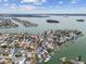 High-angle aerial view showcasing waterfront homes with private boat docks along tranquil canals, a boater's paradise at 301 Boca Ciega Dr, Madeira Beach, FL 33708