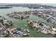 Panoramic aerial view displays waterfront homes with individual boat docks, located in a tranquil, interconnected canal neighborhood at 301 Boca Ciega Dr, Madeira Beach, FL 33708