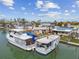 Waterfront property featuring boats docked near charming coastal homes under a bright blue sky at 301 Boca Ciega Dr, Madeira Beach, FL 33708