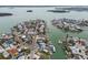 Scenic aerial shot of waterfront homes with private docks, lining winding canals in a charming coastal community at 301 Boca Ciega Dr, Madeira Beach, FL 33708
