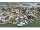 Scenic aerial view of waterfront homes with boat docks, situated along winding canals in a vibrant neighborhood at 301 Boca Ciega Dr, Madeira Beach, FL 33708