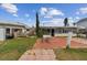 Outdoor space featuring a patio, a well-maintained lawn and nearby dock at 301 Boca Ciega Dr, Madeira Beach, FL 33708