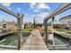 Waterfront view featuring a private dock, offering direct access to the water and boat lifts at 301 Boca Ciega Dr, Madeira Beach, FL 33708