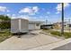 Driveway scene showcasing a boat, trailer, and garage, all under a bright, cloudy sky at 301 Boca Ciega Dr, Madeira Beach, FL 33708
