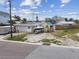 Exterior of a home with a garage, a boat on a trailer, and a partially fenced yard at 301 Boca Ciega Dr, Madeira Beach, FL 33708