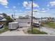 Exterior view of the home with a garage, boat, and trailer, located in a waterfront neighborhood at 301 Boca Ciega Dr, Madeira Beach, FL 33708