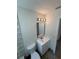 A bathroom featuring a white vanity, mirror, modern lighting, and patterned tile at 3924 Orchard Hill Cir, Palm Harbor, FL 34684