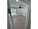A naturally lit bedroom features a ceiling fan and neutral-toned wood-look flooring at 3924 Orchard Hill Cir, Palm Harbor, FL 34684