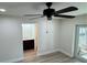 Bedroom with ceiling fan, new floors, and en suite bathroom with wood vanity and sink at 3924 Orchard Hill Cir, Palm Harbor, FL 34684