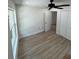 A bright bedroom features wood-look floors, a ceiling fan, and a double door closet at 3924 Orchard Hill Cir, Palm Harbor, FL 34684