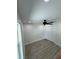 This bedroom features wood-look flooring, a ceiling fan, and a closet at 3924 Orchard Hill Cir, Palm Harbor, FL 34684