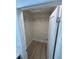 A walk-in closet with wood-look flooring and adjustable shelving at 3924 Orchard Hill Cir, Palm Harbor, FL 34684