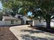 Charming single-Gathering home with a long driveway and well-maintained landscaping around mature shade trees at 3924 Orchard Hill Cir, Palm Harbor, FL 34684